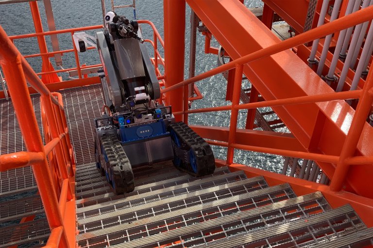 A robotic vehicle navigating stairs on an offshore platform, showcasing advanced technology in marine environments