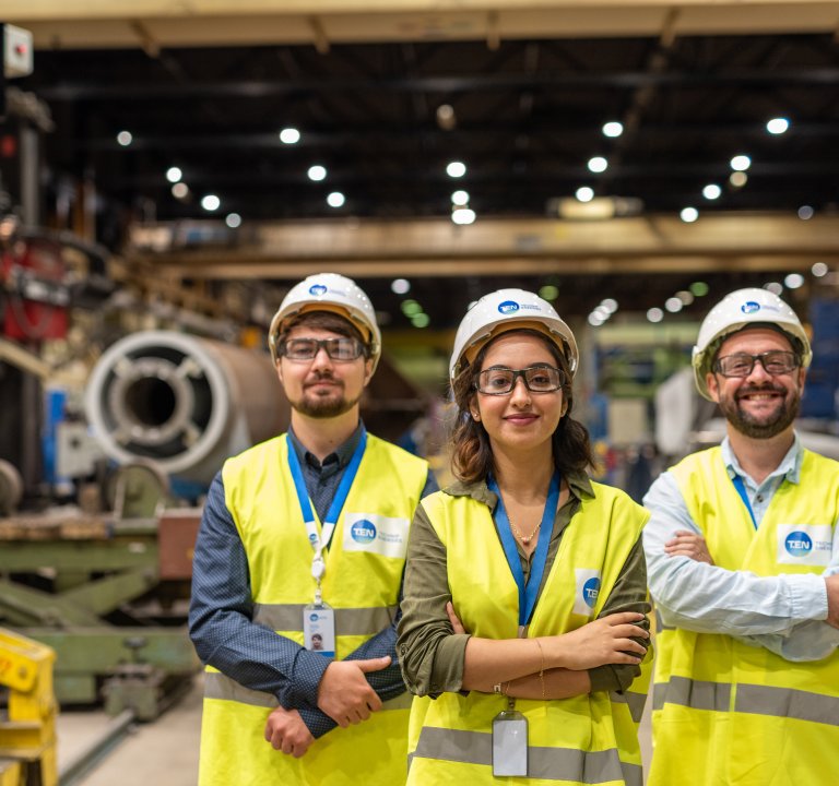 Three Technip Energies employees onsite wearing safety gear