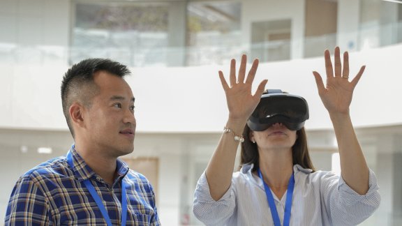 Technip Energies employees interacting with virtual reality using virtual reality goggles